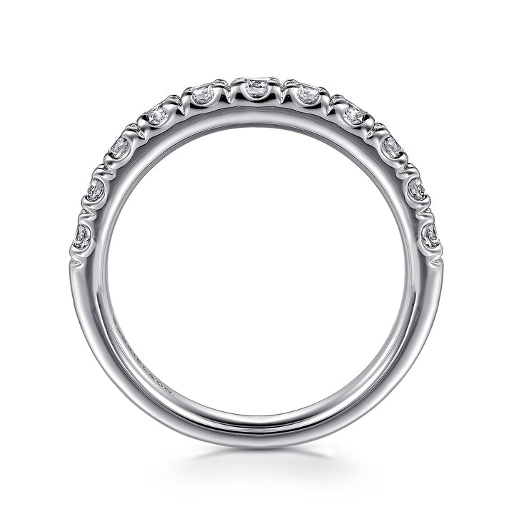 A side profile view of a white gold wedding band against a white background. The ring features a half-eternity style with a row of brilliant diamonds set in white gold.