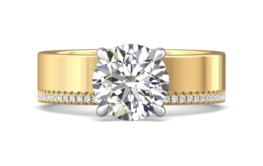 Front view of a round diamond engagement ring with white gold prongs and a wide yellow gold band edged with pavé diamonds.