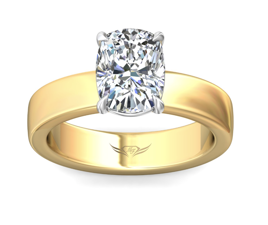 Top view of an elongated cushion-shaped diamond in a four-prong white gold setting with a wide yellow gold band.