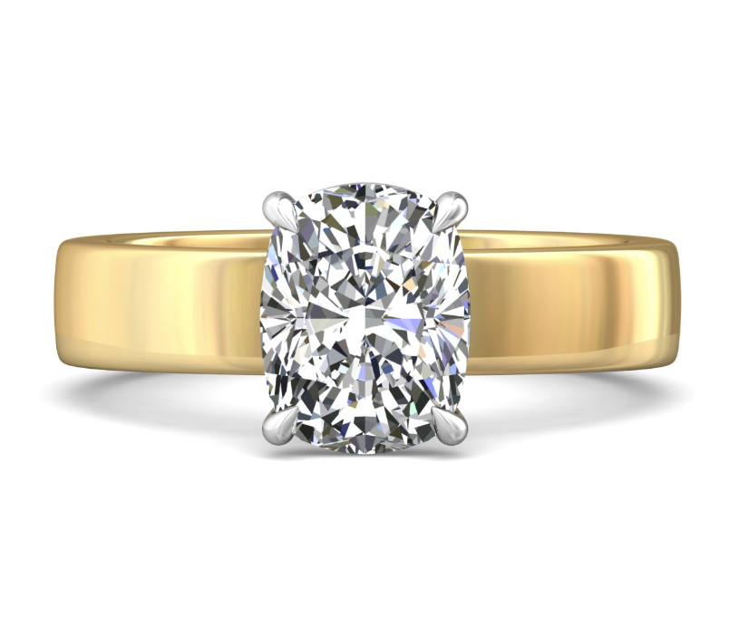 Front view of a solitaire engagement ring with an elongated cushion-shaped diamond, white gold prongs and a wide yellow gold band.