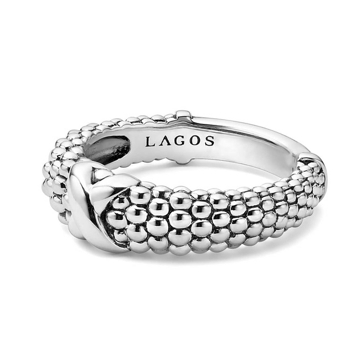 A side view of a sterling silver ring against a white background. The ring features an X-shaped design and classic caviar beading.