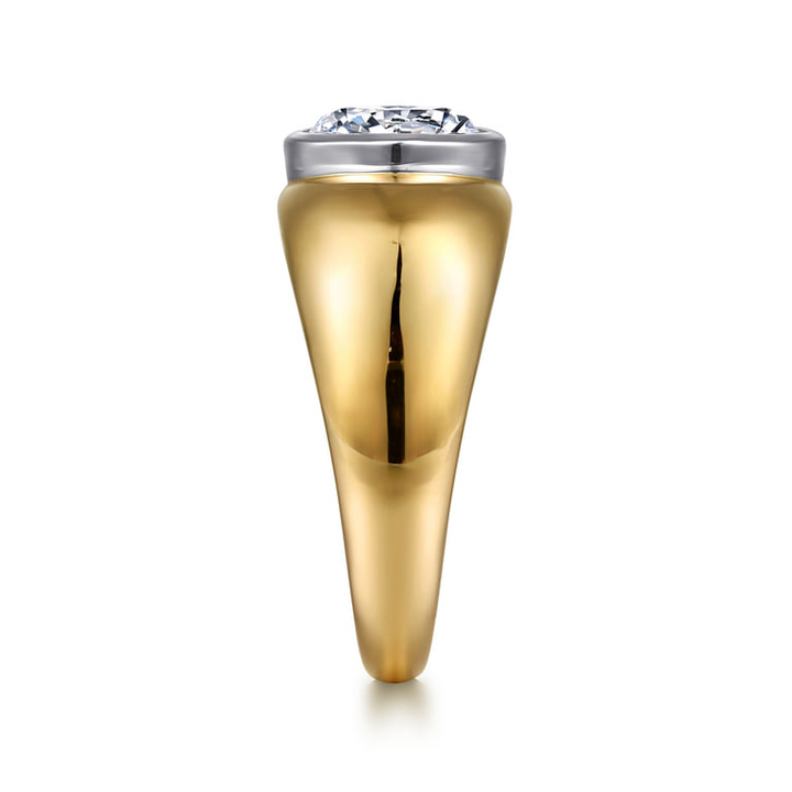 End view of a yellow gold dome engagement ring showing the white gold bezel and wide shoulders tapering toward the base.